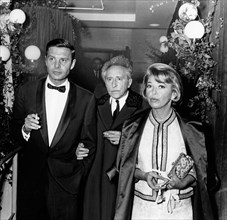 Cocteau between Louis Jourdan and his wife, 1962