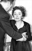 Edith Piaf  exhausted, she is supported by her manager Lou Barrier, December 14, 1959