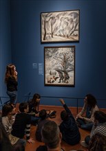 A group of children before two works by Natalia Goncharova