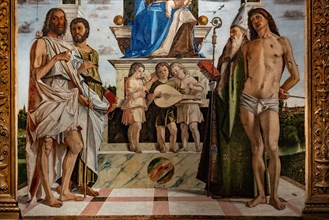 “Enthroned Madonna with infant Jesus  among Saints John the Baptist, Bartholomew, Agustine, Sebastian and three angels playing music”, by Bartolomeo Montagna