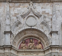 Montepulciano, church of St. Augustine: detail of the portal with the lunette with the terracotta