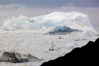 A boat sailing on the pack ice, Disko bay, Ilulissat, Groenland