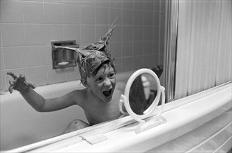 Young Boy Playing in Bathtub