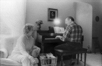 Elderly Couple Singing and Playing Piano