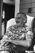 Elderly Woman Sitting on Porch
