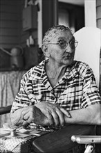 Elderly Woman Sitting on Porch