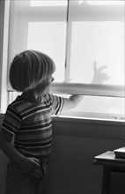 Young Boy Making Shadow Puppet