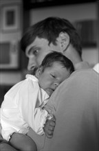 Father Holding Newborn Baby