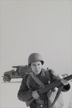 Military Soldier in Uniform Pointing Rifle Portrait, WWII, HQ 2nd Battalion, 389th Infantry, US Army Military Base, Indiana, USA, 1942