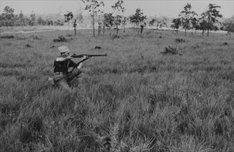 Kneeling Soldier Displaying Proper Shooting Position in Field During Training Session, WWII, 2nd Battalion, 389th Infantry, US Army Military Base Indiana, USA, 1942