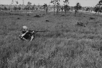 Sitting Soldier Displaying Proper Shooting Position in Field During Training Session, WWII, 2nd Battalion, 389th Infantry, US Army Military Base Indiana, USA, 1942