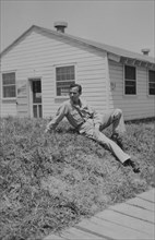 Soldier Relaxing on Ground Near Military Building, WWII, 325th Infantry, US Army Military Base, Camp Claiborne, Louisiana, USA, 1942