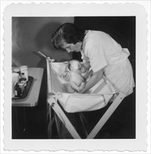Mother Bathing Newborn Baby, 1952