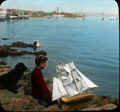 Boy and Dog with Miniature Ship on Lakeshore, "The Captain of a Tidy Little Ship", USA, Magic Lantern Slide, circa 1910