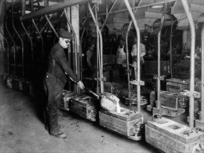 Worker Pouring Castings at Automobile Manufacturer, Detroit, Michigan, USA, Detroit Publishing Company, 1920
