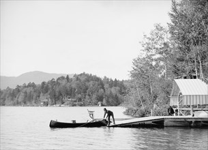 Man Launching Canoe into Water, Upper St. Regis Lake, Adirondack Mountains, Franklin County, New York, USA, Detroit Publishing Company, 1903