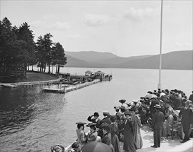 Group of People on Boat Approaching Sagamore Dock, Green Island, Lake George, New York, USA, Detroit Publishing Company, 1904