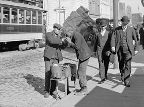 Man Lighting Another Man's Cigarette on City Street, Detroit Publishing Company, 1905