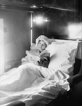 Woman Reading Book in Electric-Lighted Berth on Deluxe Overland Limited Train, USA, Detroit Publishing Company, 1915