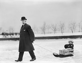 Man Pulling Child on Sled, Washington DC, USA, Harris & Ewing, 1912
