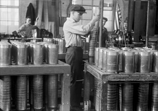 Worker Handling and Packing Cartridge Cases, Navy Yard, Washington DC, USA, Harris & Ewing, 1917