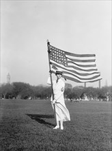 Female Navy Yeoman in White Summer Dress Uniform Holding American Flag, USA, Harris & Ewing, 1917