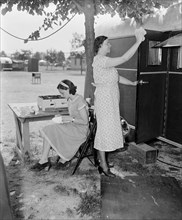 Mother and Daughter Doing Chores at Trailer Camp, Harris & Ewing, June 4, 1937