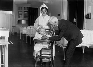 Doctor with Nurse Examining Baby at Hospital, USA, Harris & Ewing, 1915