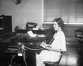 Woman Working with Dictaphone and Typewriter in Office, USA, Harris & Ewing, 1932