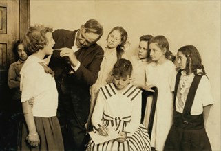 Doctor Conducting Medical Inspection and Examining Throats of Children in Grade 6, Lawton, Oklahoma, USA, Lewis Hine, 1917