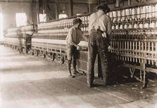 Young Boy Assisting in Removing Spindles at Cotton Factory, Cherryville, North Carolina, USA, Lewis Hine, 1908