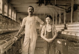 Portrait of Mule Spinner and Young Assistant at Cotton Mill, Burlington, Vermont, USA, Lewis Hine, 1909