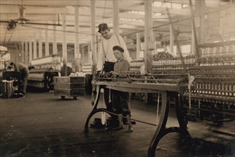 Young "Band-Boy" and Overseer, Yarn Mill, Yazoo City, Mississippi, USA, Lewis Hine, 1911