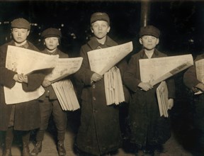 Four Young Newsboys Selling Newspapers at Hudson Tunnel Station, Jersey City, New Jersey, USA, Lewis Hine, 1909
