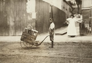 Young Boy Delivering Boxes with Push Cart, Roxbury, Massachusetts, USA, Lewis Hine, 1912