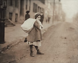 Young Girl Carrying Sack of Hosiery Supporters Home after Leaving Work and Before she Goes off to School, Worcester, Massachusetts, USA, Lewis Hine, 1912