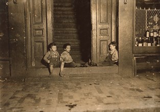 Three Young Children Hanging Out in Doorway Late at Night, Boston, Massachusetts, USA, Lewis Hine, 1909