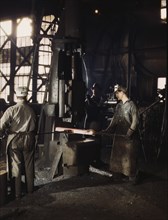 Workers Using Small Steam Drop Hammer at Blacksmith Shop, Santa Fe Railroad Shop, Topeka, Kansas, USA, Jack Delano for Office of War Information, 1943