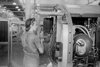 Female Worker Installing Electric Wiring in Fuselage, Vultee Aircraft Company, Nashville, Tennessee, USA, Jack Delano for Office of War Information, August 1942