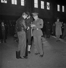 Military and Naval Police Help Recruit on his Way, Union Station, Chicago, Illinois, USA, Jack Delano for Office of War Information, January 1943
