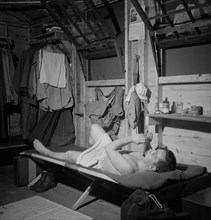 Enlisted Man in Barracks Playing Flute after Taking Shower, Air Service Command, Greenville, South Carolina, USA, Jack Delano for Office of War Information, July 1943