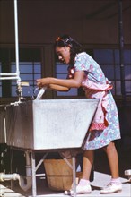 Young Woman at Community Laundry, Farm Security Administration (FSA) Camp, Robstown, Texas, USA, Arthur Rothstein for Farm Security Administration, January 1942