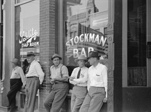 Stockmen in Front of Bar, Main Street, Miles City, Montana, USA, Arthur Rothstein for Farm Security Administration, June 1939