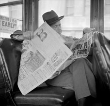 Man Reading Newspaper on Bus, Monday Morning after Japanese Attack on Pearl Harbor, San Francisco, California, USA, Office of War Information, December 8, 1941