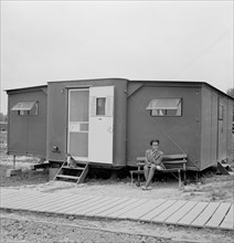Young Woman Sitting Outside Farm Security Administration (FSA) Trailer Camp Project for African-Americans, Exterior of Expansible Trailer, Arlington, Virginia, USA, Marjorie Collins for Farm Security ...