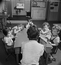 Story Hour, Nursery School in Federal Housing Project run Cooperatively by Mothers, Greenbelt, Maryland, USA, Marjorie Collins for Farm Security Administration, May 1942