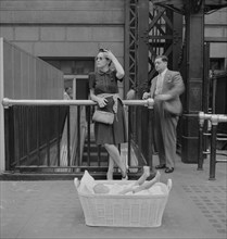Woman with Baby in Basket Waiting for Train, Pennsylvania Station, New York City, New York, USA, Marjorie Collins for Office of War Information, August 1942