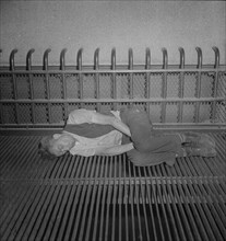 Bum Sleeping on Grate, the Bowery near 7th Street, New York City, New York, USA, Marjorie Collins for Office of War Information, September 1942