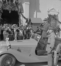 General Charles de Gaulle, Accompanied by General Charles Mast, Saluting as Band Plays Marseillaise Outside Summer Palace of Bey of Tunis, Carthage, Tunisia