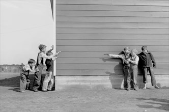 School Children Playing with Toy Guns, Farm Security Administration (FSA) Camp, Weslaco, Texas, USA, Arthur Rothstein for Farm Security Administration (FSA), January 1942
